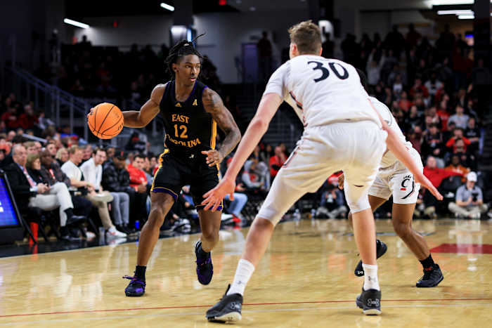 Jan 11, 2023; Cincinnati, Ohio, USA; East Carolina Pirates guard Javon Small (12) controls the ball against the Cincinnati Bearcats in the second half at Fifth Third Arena. Mandatory Credit: Aaron Doster-USA TODAY Sports